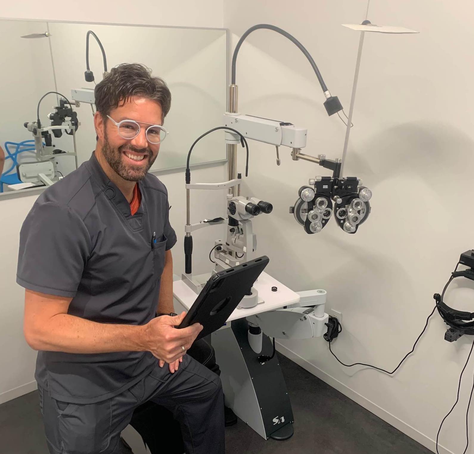 Dr. Matt Barber in an examination room at CHROMA modern Eyewear Eyecare in Fort Worth, TX.