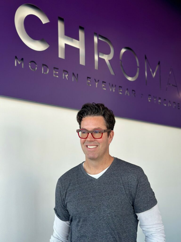 Dr. Matt Barber modeling a pair of Etnia frames glasses at CHROMA's practice in Fort Worth.