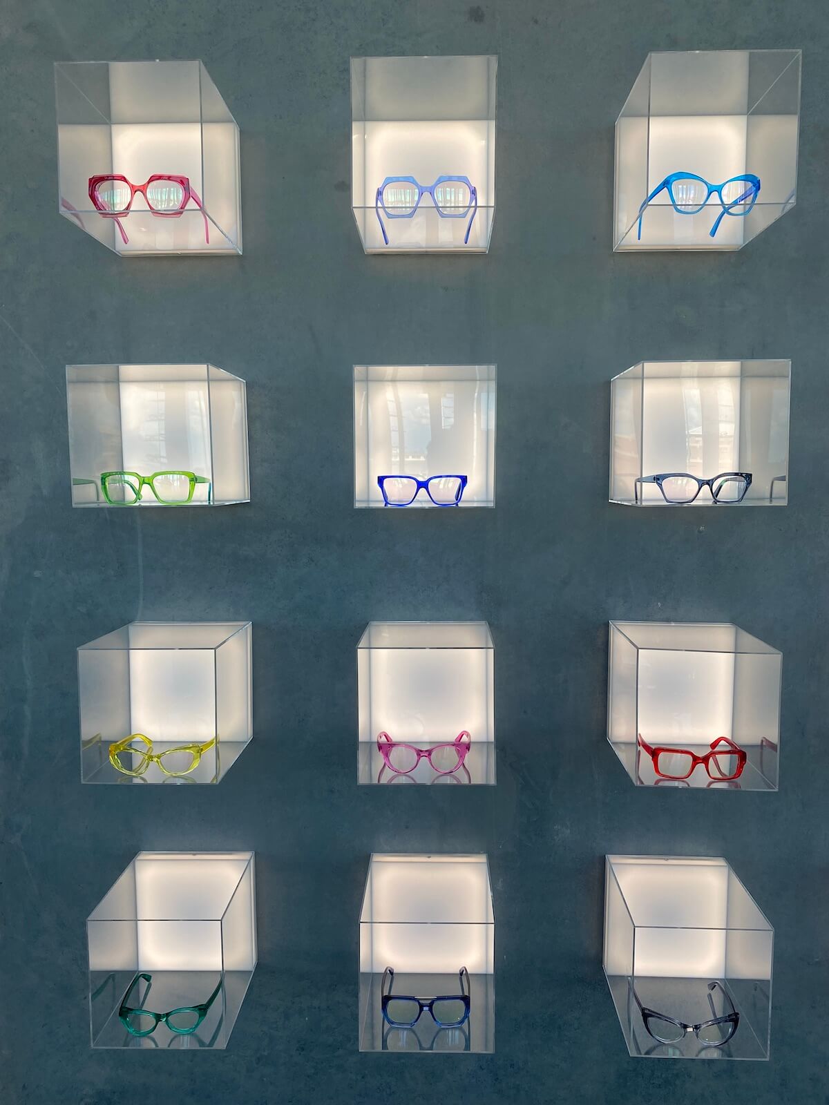 Acrylic cube display with glasses at CHROMA modern Eyewear Eyecare in Fort Worth, Texas.