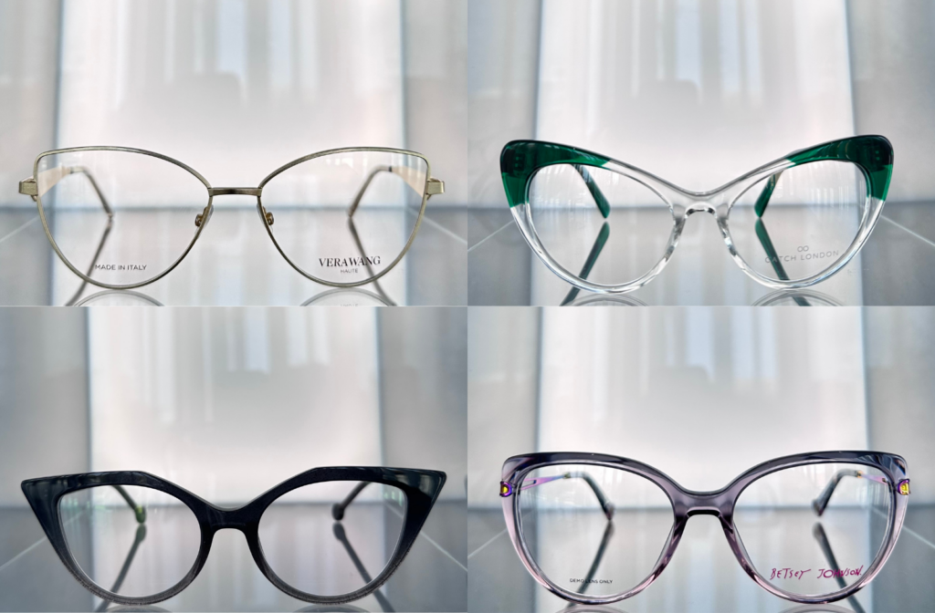 Four cat-eye eyeglass frames in gold, green, black, and purple styles displayed on a glass shelf.